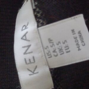 Kenar size small mini skirt. It is black with white lines. The fabric stretchy.